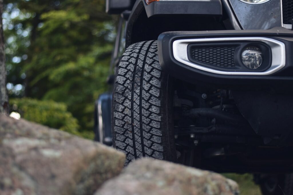 Closeup on a front tire of Jeep Sahara. Adventure is waiting